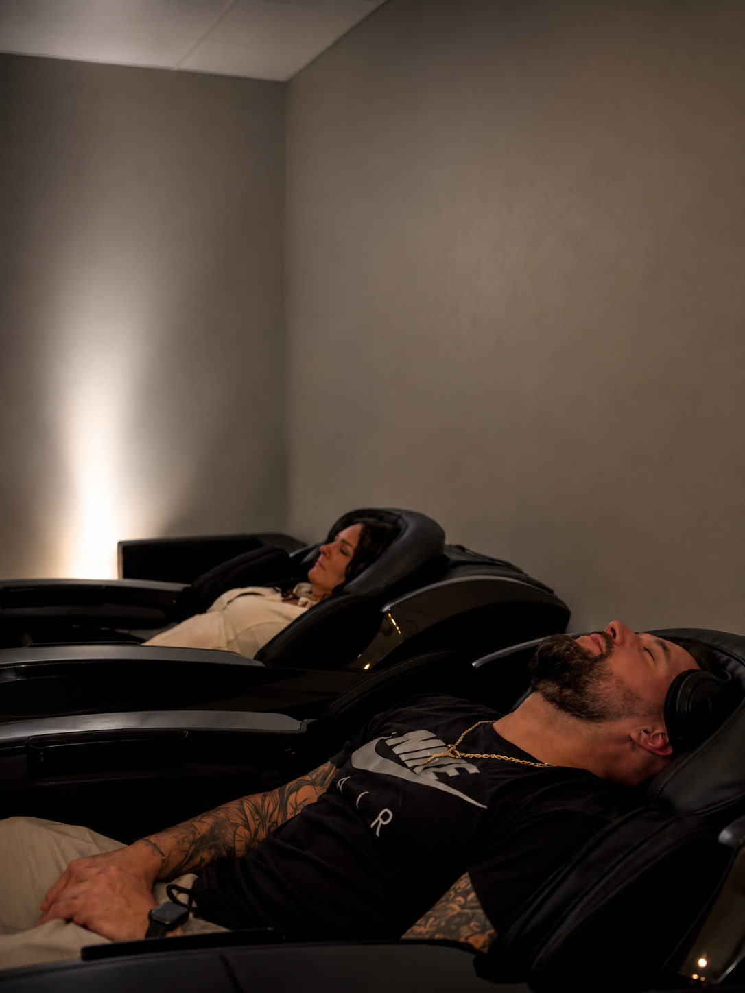 Guest enjoying a massage chair session at Float G.O.A.T.S.